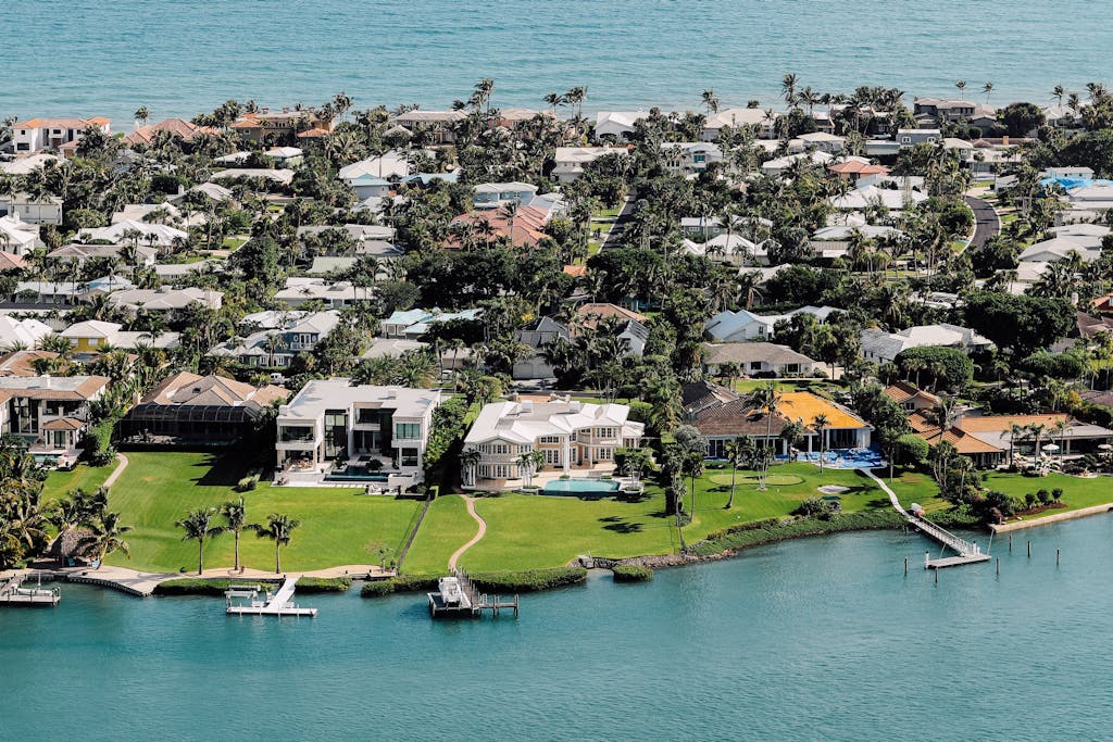 Aerial view of luxurious waterfront mansions on a tropical island.